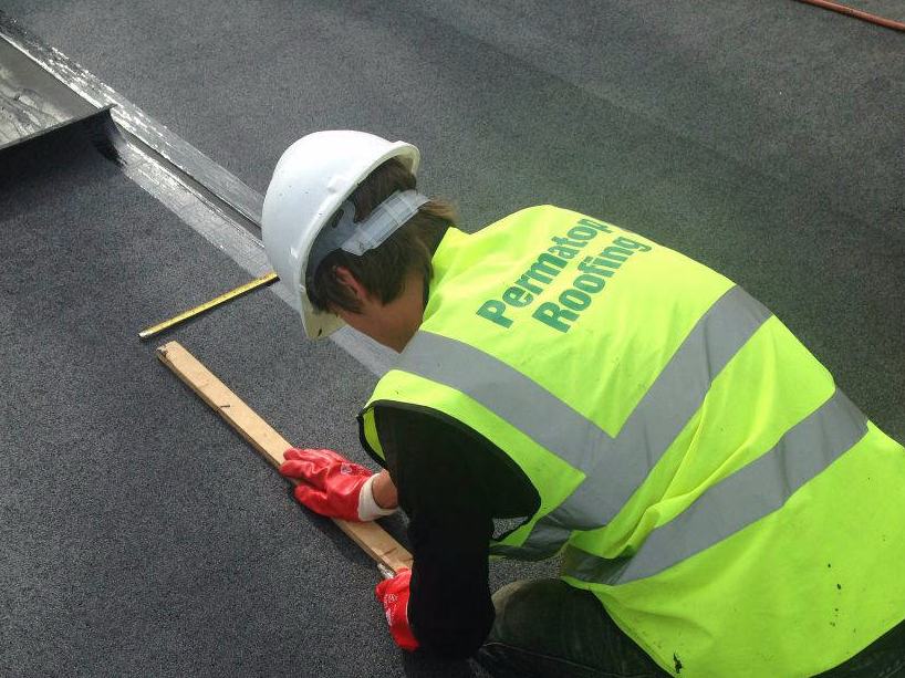 Permatop Roofing operative installing a bituminous membrane